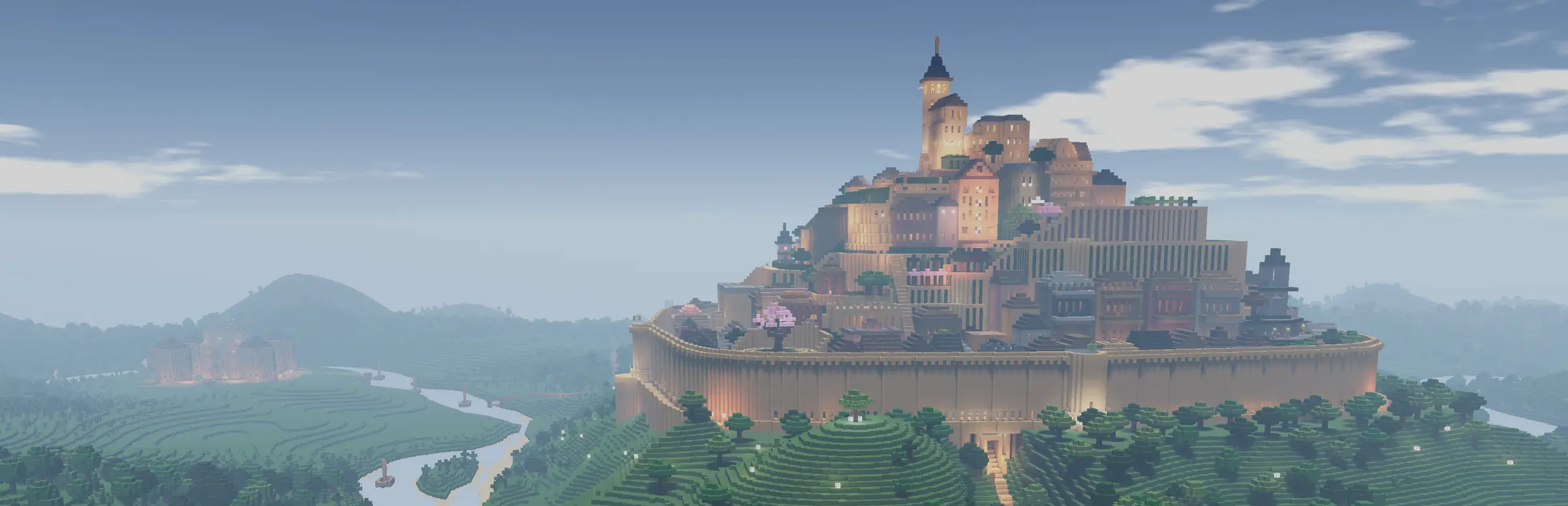 Colony Survival server hosting: a blocky walled castle town rises on a hill above green forests and a winding river