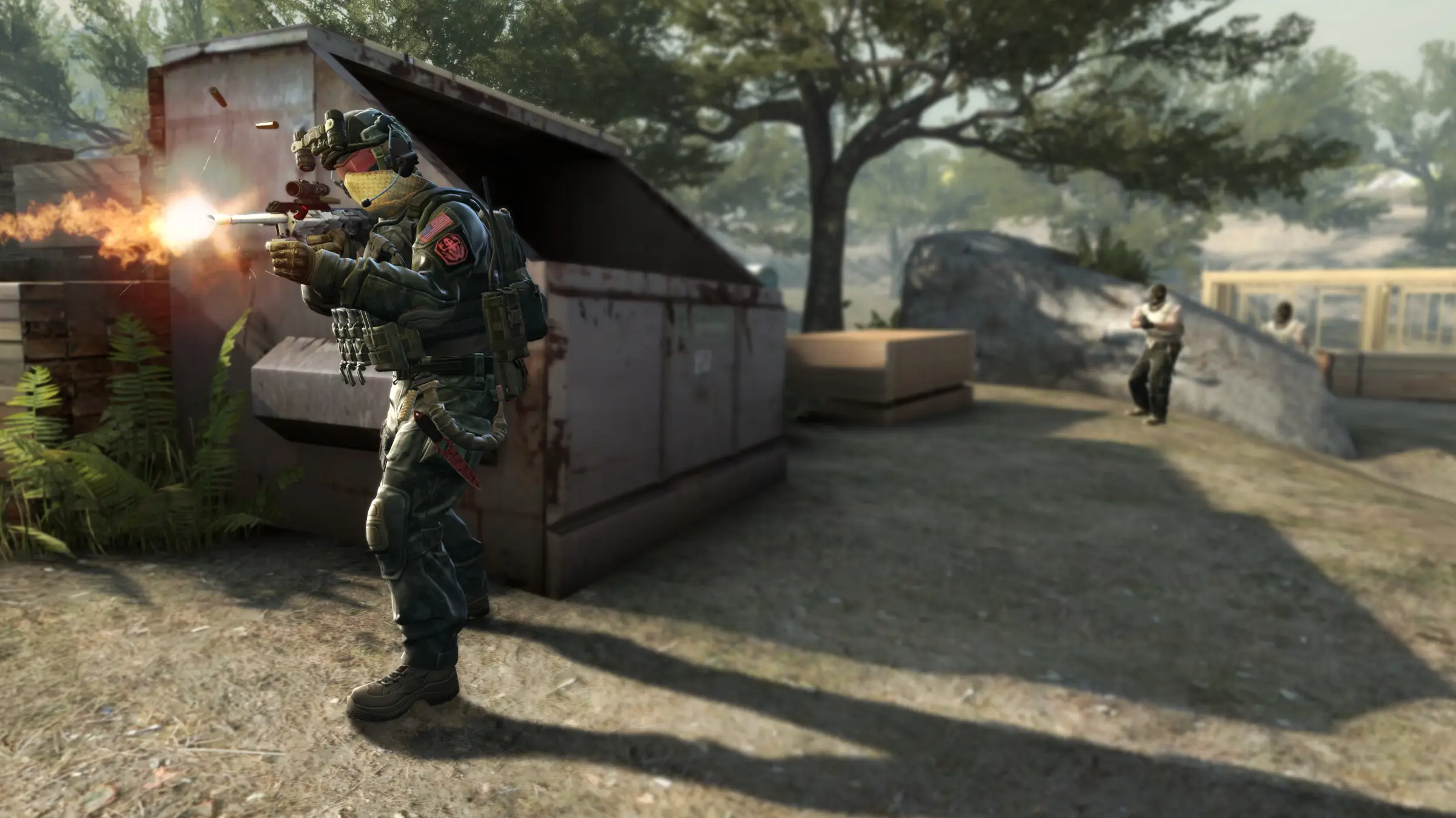 Counter-Strike: Global Offensive server hosting: a counter-terrorist fires his rifle from behind a green dumpster as a terrorist runs across a sunny park on Overpass