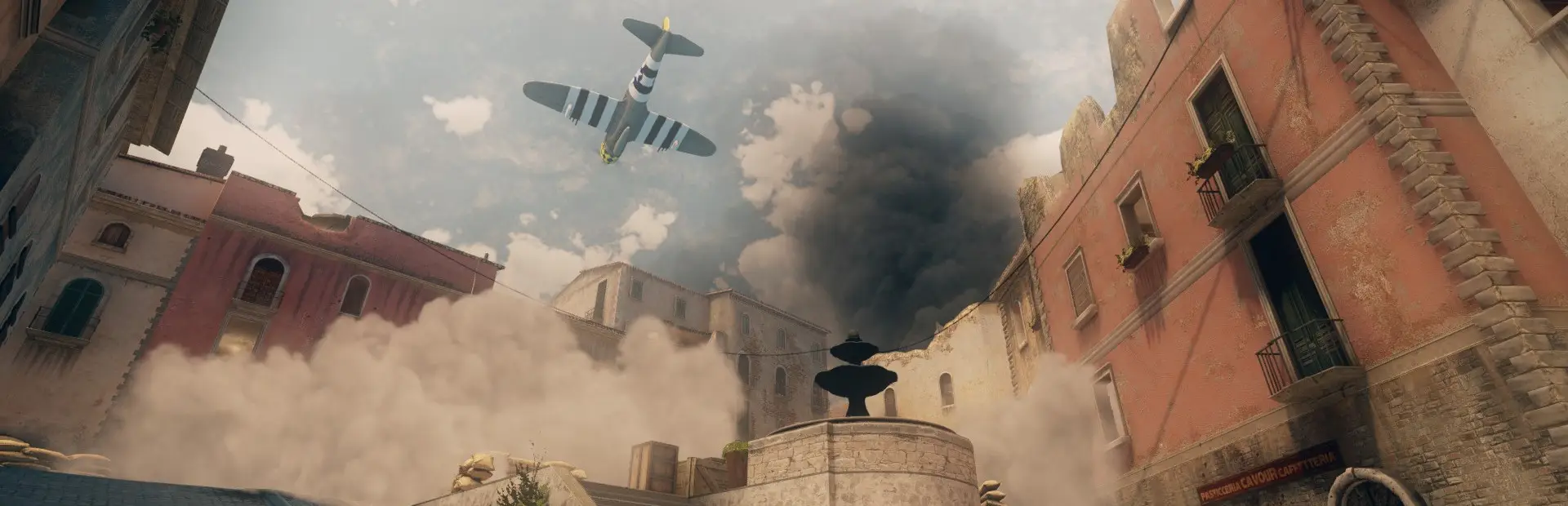 Day of Infamy server hosting: a fighter plane swoops over smoke drifting between the sunlit stone buildings of an Italian town square