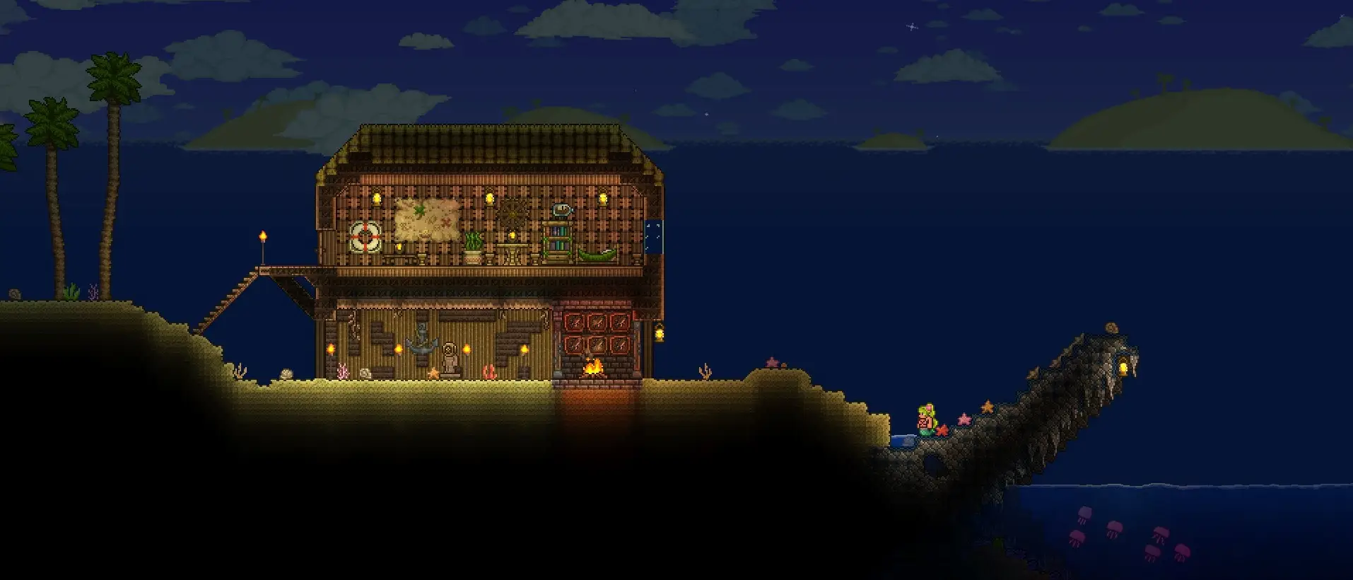 Terraria Mobile server hosting: a pixel-art wooden house lit by lanterns stands on a dark beach by the night sea