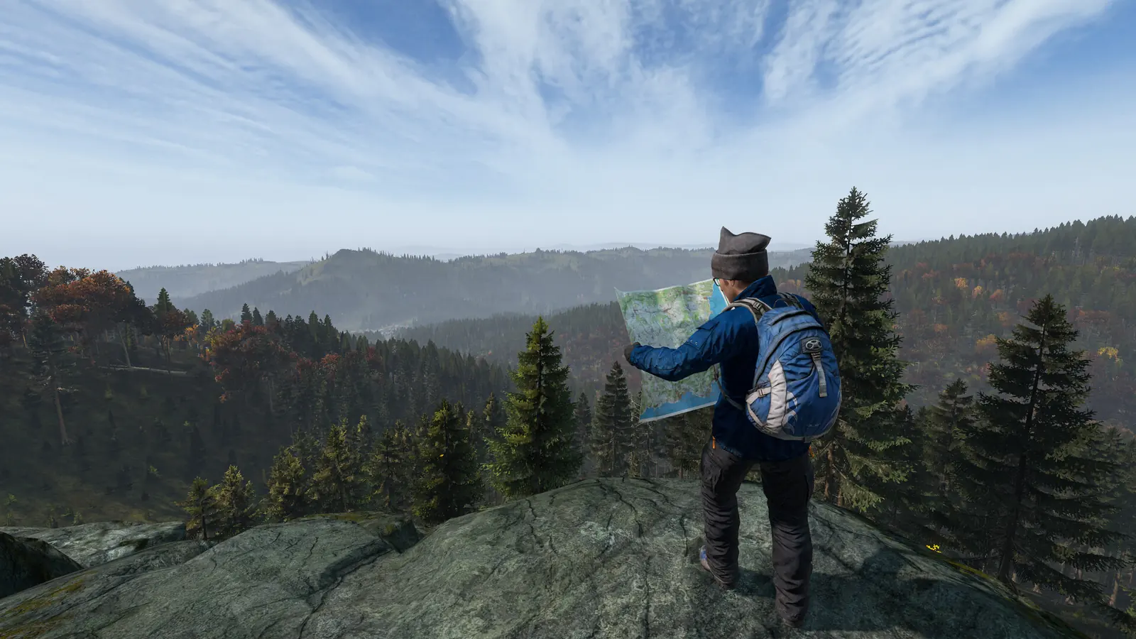 DayZ server setup: a survivor in a blue jacket stands on a rocky ridge reading a paper map above forested hills