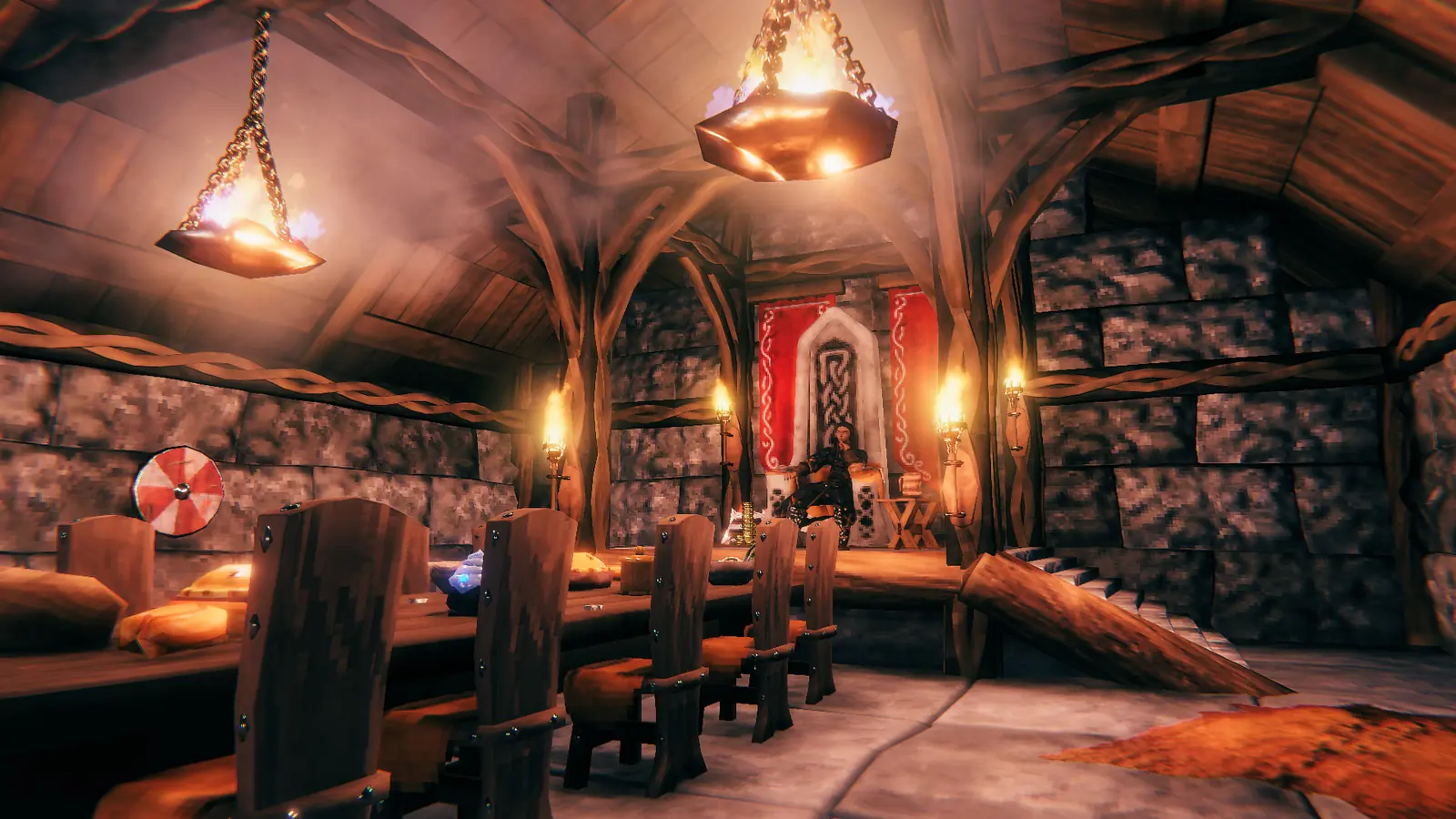 Valheim server setup: a Viking sits on a carved throne at the far end of a torch-lit longhouse, beyond a long feasting table and a painted shield on the wall